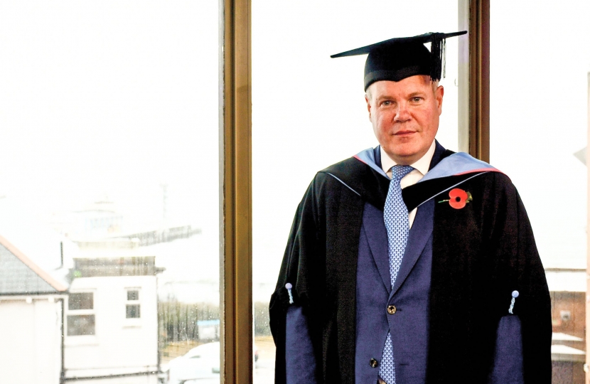 Conor pictured in his mortarboard and robes in preparation for the graduation ceremony. 