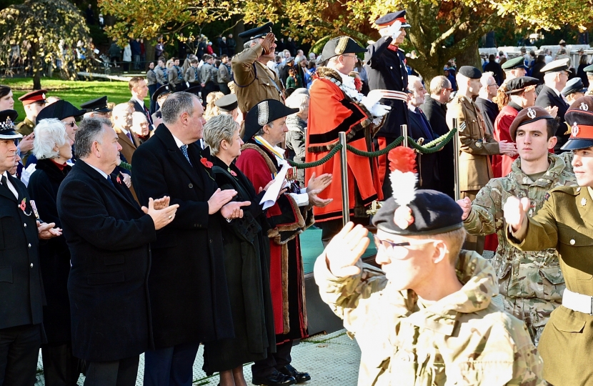 Conor applauding as service men and women walk past in the Remembrance Service Parade.