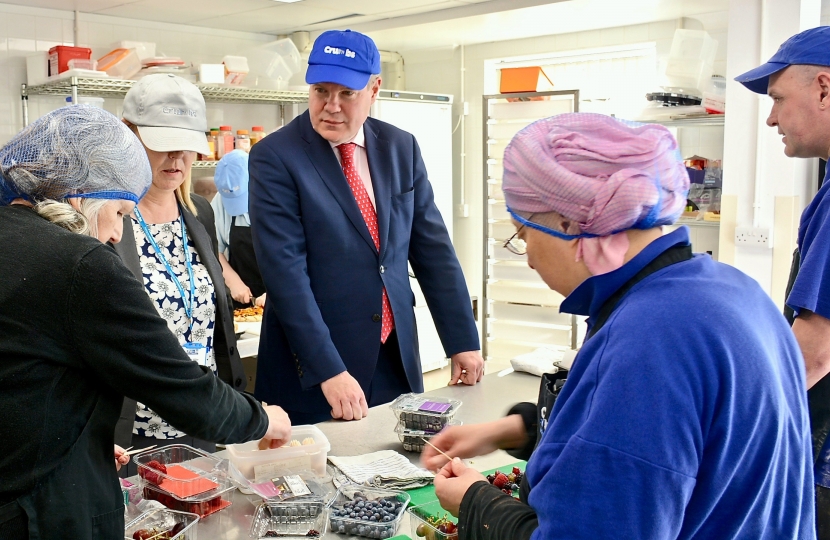 Conor pictured being shown the preparation for the canapés.