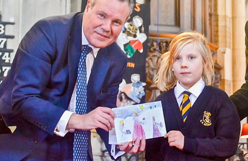 Conor with Charlotte Crowe from St Luke's School, Winton, and her winning design from Conor's Christmas Card Competition 2017 in print.