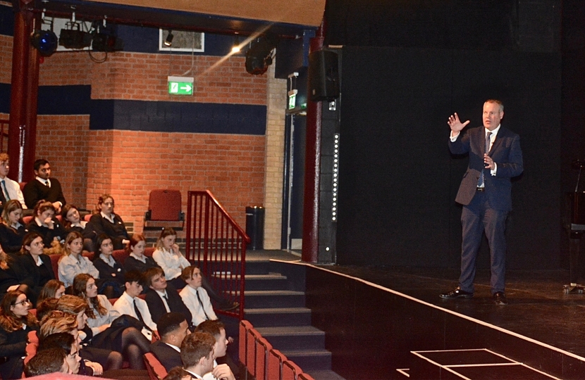 Conor pictured giving a speech to Canford School students about his role as an MP.