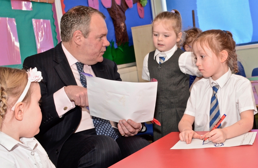 Conor pictured being shown a drawing by a student at Talbot Primary. 