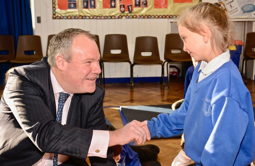 Conor pictured shaking hands with a student. 