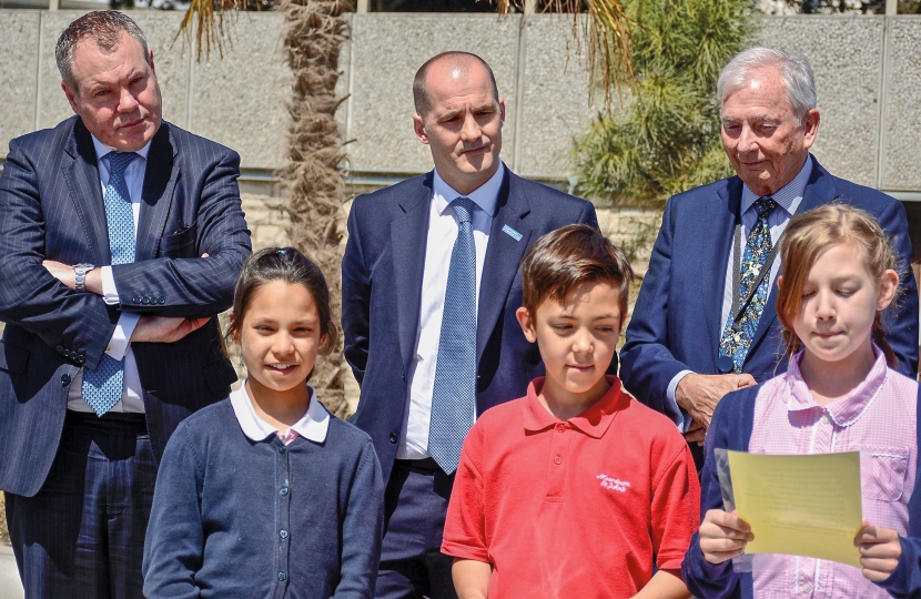 Conor pictured unveiling the plaque with the Minister and local children. 