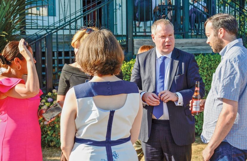 Conor talking with guests at the event.