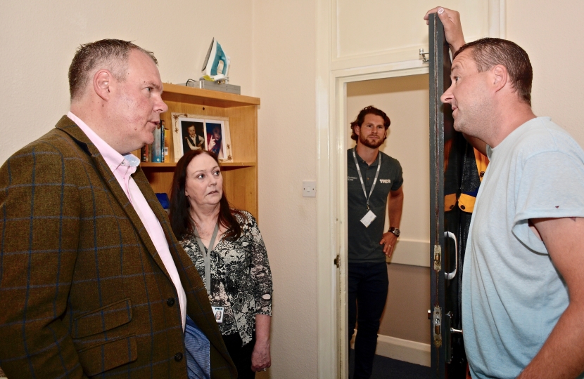 Conor talking with a resident at the YMCA in Bournemouth.