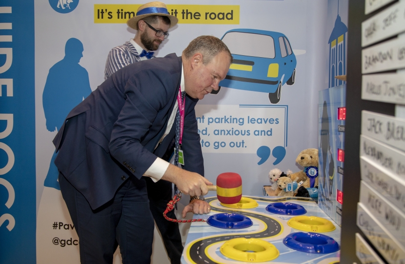 Conor participating in the Guide Dogs' specially-themed whack-a-mole game to illustrate the problem of pavement parking.