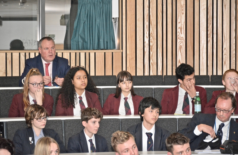 Conor watches the pupils present their ideas.