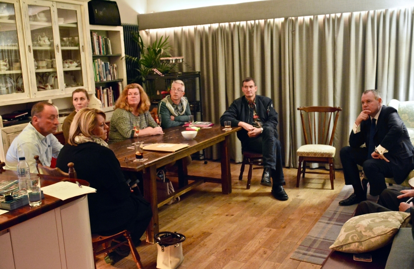 Conor listening to residents' concerns at a house meeting.