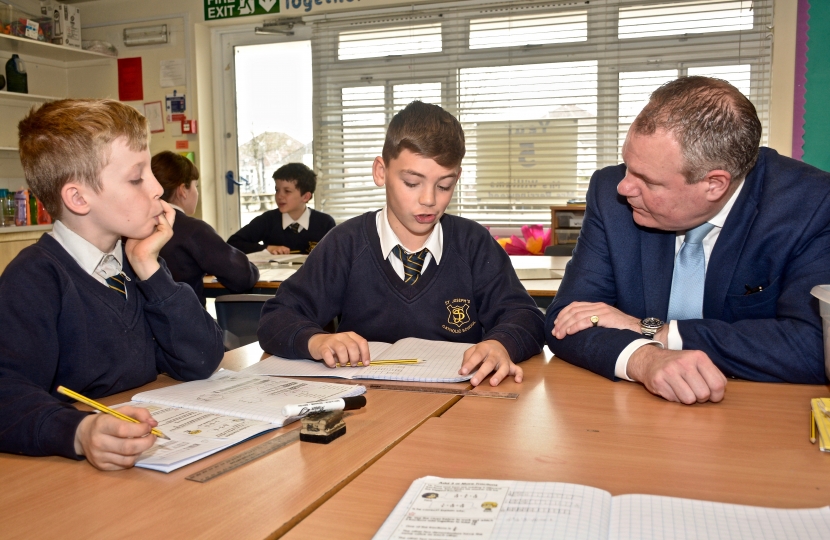 Pupils at St Joseph's School show Conor their work.