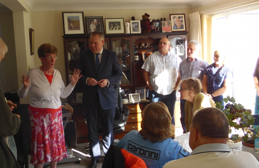 Conor addressing a house meeting in Alderney.