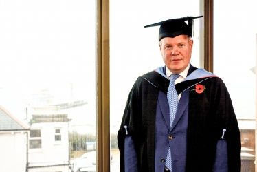 Conor pictured in his mortarboard and robes in preparation for the graduation ceremony. 