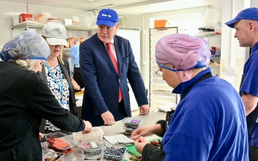 Conor pictured being shown the preparation for the canapés.