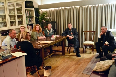 Conor listening to residents' concerns at a house meeting.