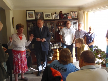 Conor addressing a house meeting in Alderney.