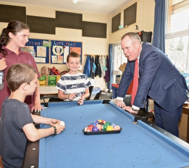 Conor chatting to some of the children who use the Fernheath Play centre over a game of pool.